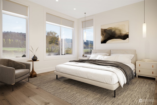 bedroom with recessed lighting, baseboards, and wood finished floors