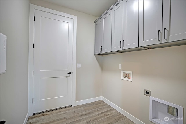 clothes washing area featuring light hardwood / wood-style floors, electric dryer hookup, washer hookup, and cabinets