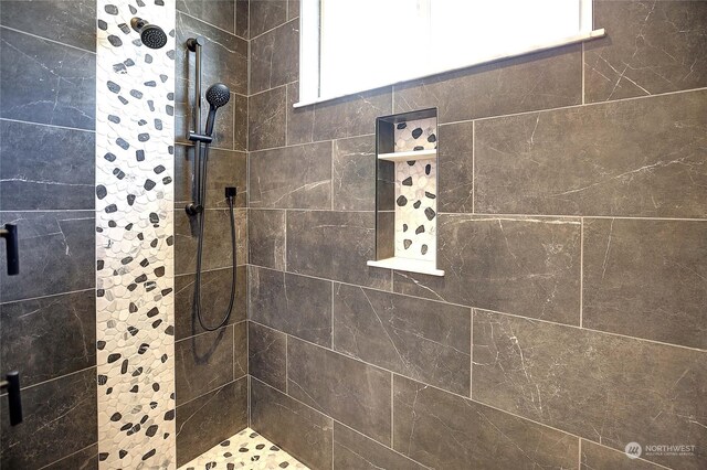 bathroom with a tile shower