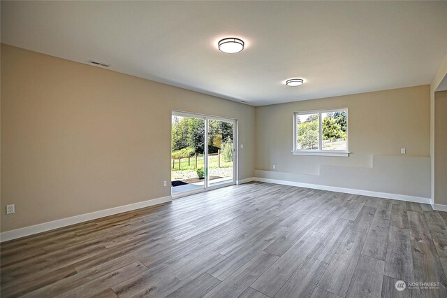 spare room with hardwood / wood-style floors