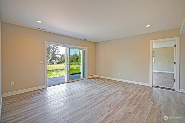 spare room featuring light wood-type flooring