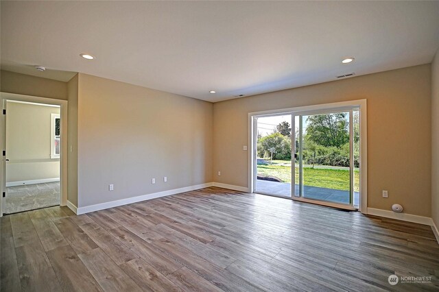 empty room with wood-type flooring