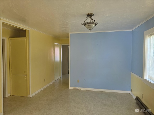 unfurnished room with a baseboard heating unit, a textured ceiling, plenty of natural light, and crown molding