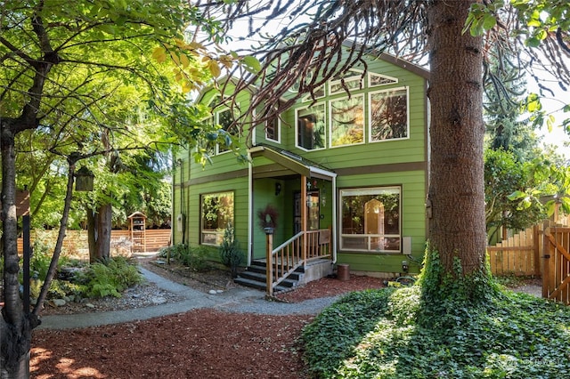 view of front of home featuring fence