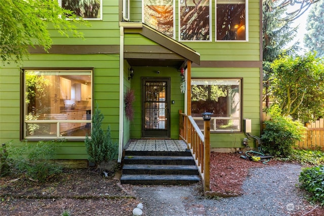 view of exterior entry with fence