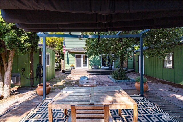 view of patio featuring a deck and an outbuilding