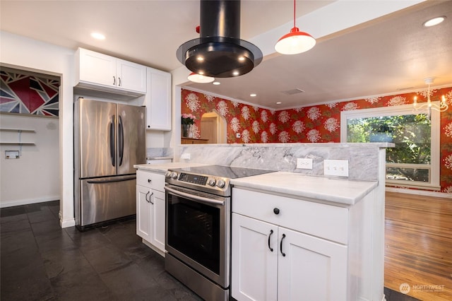 kitchen with wallpapered walls, appliances with stainless steel finishes, light countertops, white cabinetry, and recessed lighting