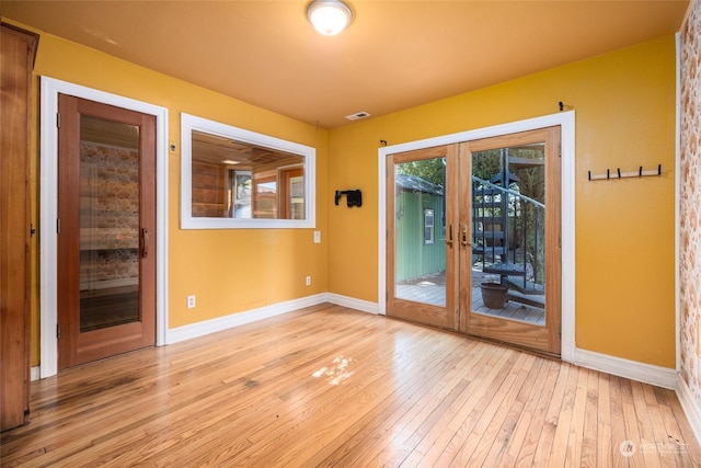 interior space featuring french doors, baseboards, visible vents, and hardwood / wood-style floors