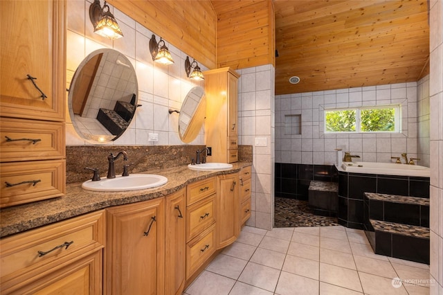 full bathroom featuring double vanity, tile patterned flooring, a sink, and tile walls