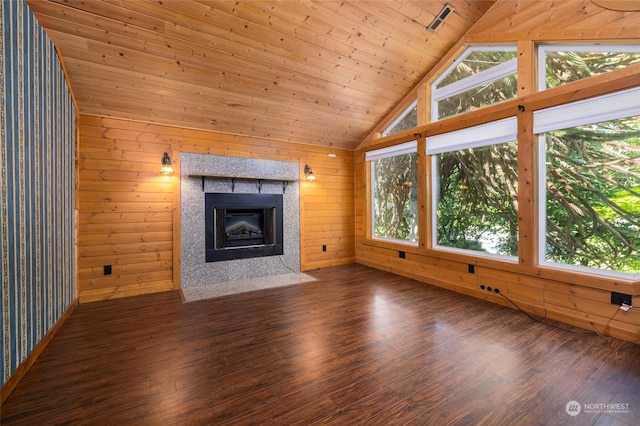 unfurnished living room with wood ceiling, a fireplace with flush hearth, wood finished floors, vaulted ceiling, and wood walls