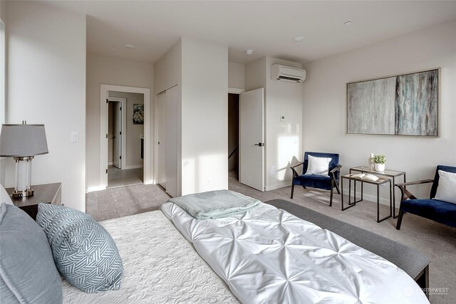 bedroom featuring light carpet and a wall mounted air conditioner