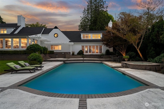 pool with an in ground hot tub, french doors, a patio, and a pergola