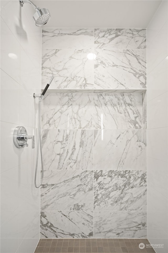 bathroom with tiled shower