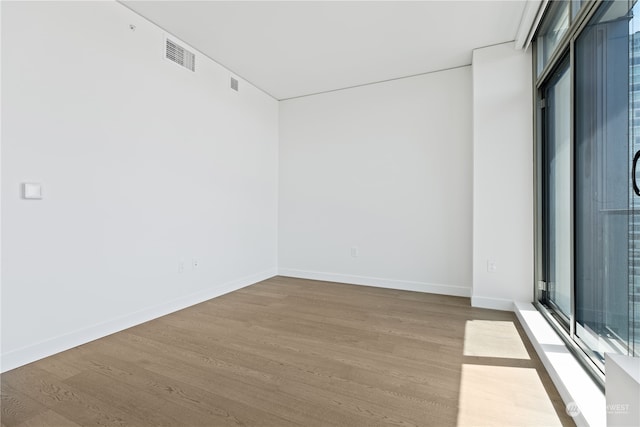 unfurnished room featuring hardwood / wood-style flooring