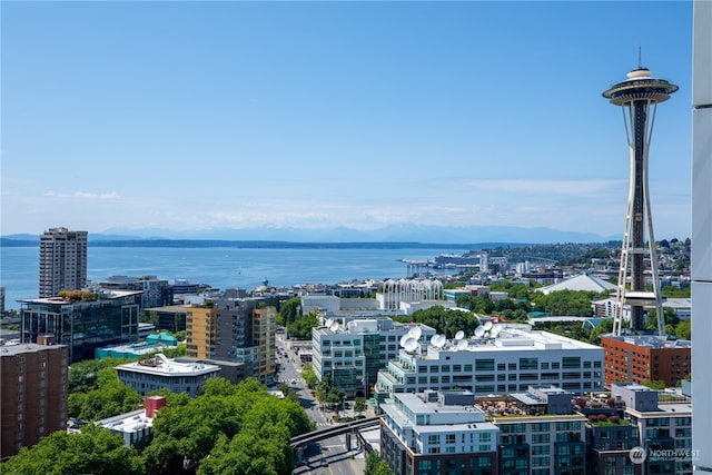 property's view of city with a water and mountain view