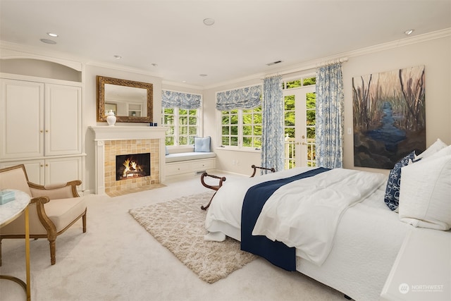 bedroom featuring crown molding, a fireplace, and light carpet