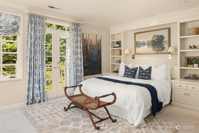 bedroom featuring crown molding, french doors, and light carpet