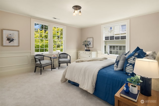 bedroom featuring light carpet and ornamental molding