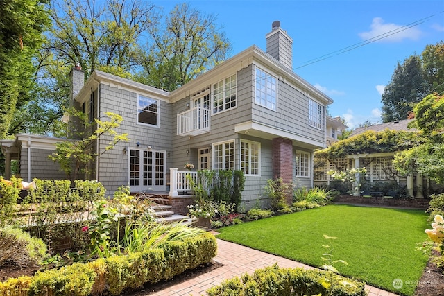 rear view of property with a lawn