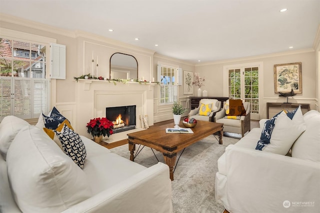 living room with ornamental molding and light hardwood / wood-style flooring