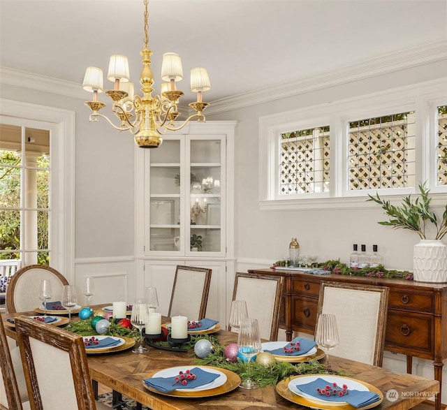 dining room with crown molding and a chandelier