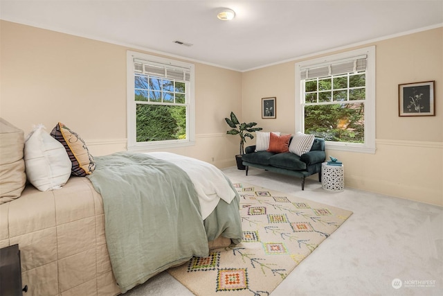 bedroom featuring multiple windows, crown molding, and carpet floors