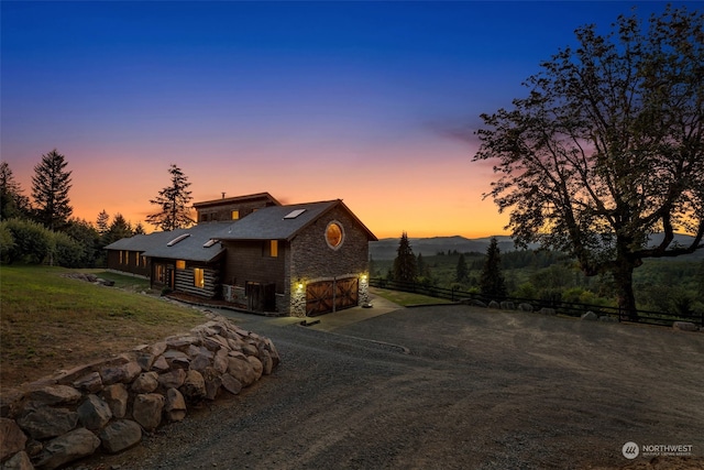 view of front of home featuring a mountain view and a lawn