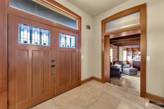 entrance foyer featuring light tile patterned floors and a wealth of natural light