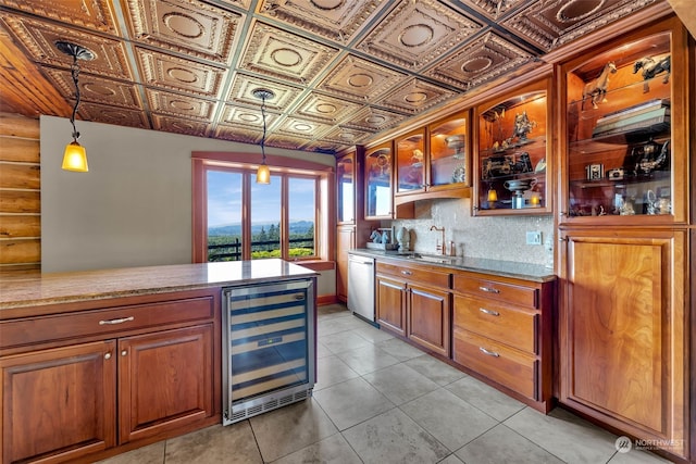 kitchen featuring wine cooler, stainless steel dishwasher, sink, and pendant lighting