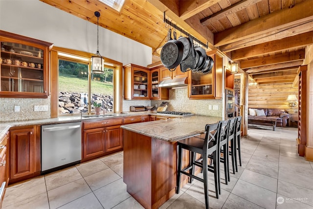 kitchen with light stone countertops, a skylight, a kitchen bar, wood ceiling, and stainless steel appliances