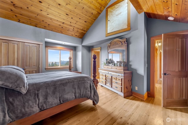 bedroom with a closet, wood ceiling, high vaulted ceiling, and light hardwood / wood-style flooring