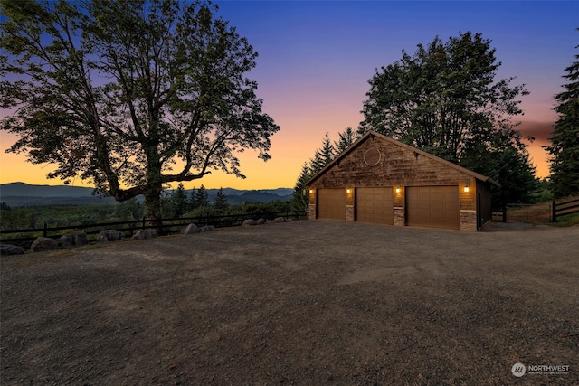 exterior space featuring an outdoor structure, a mountain view, and a garage