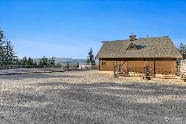 exterior space with a mountain view, an outdoor structure, and a rural view