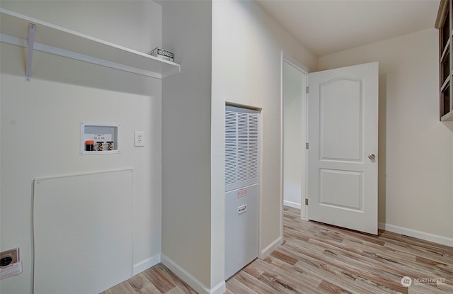 laundry area featuring hookup for a washing machine and light hardwood / wood-style floors