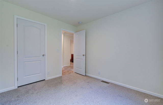 unfurnished bedroom featuring light colored carpet