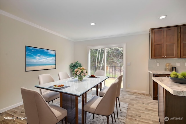 dining room with light hardwood / wood-style floors and ornamental molding