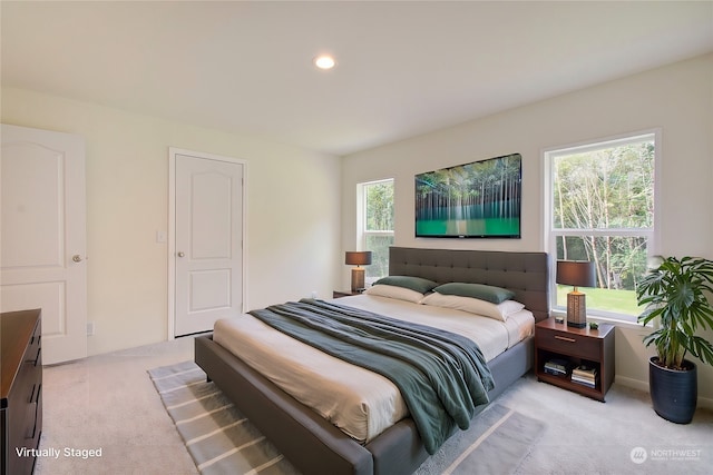 bedroom featuring light colored carpet