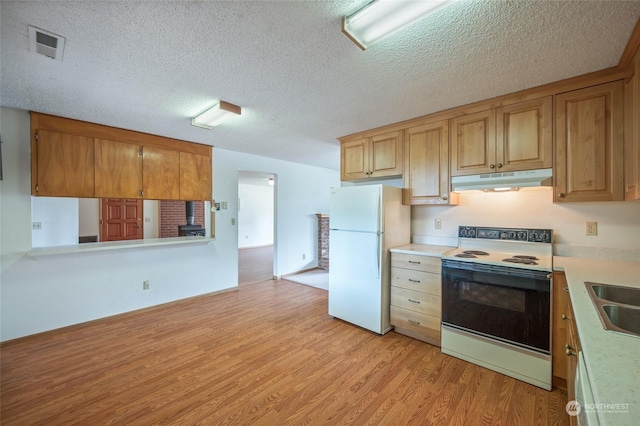 kitchen featuring freestanding refrigerator, light wood-style flooring, under cabinet range hood, light countertops, and range with electric cooktop