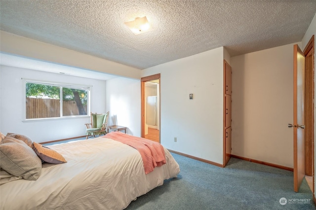 carpeted bedroom with a textured ceiling and baseboards
