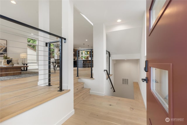 entrance foyer with light wood-style floors, stairway, visible vents, and recessed lighting