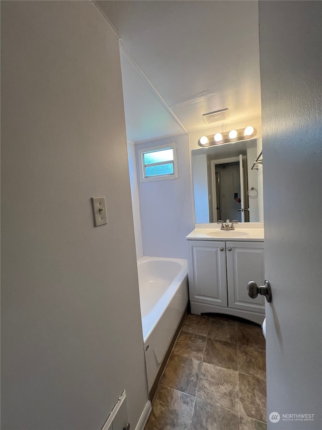 bathroom featuring vanity and a tub