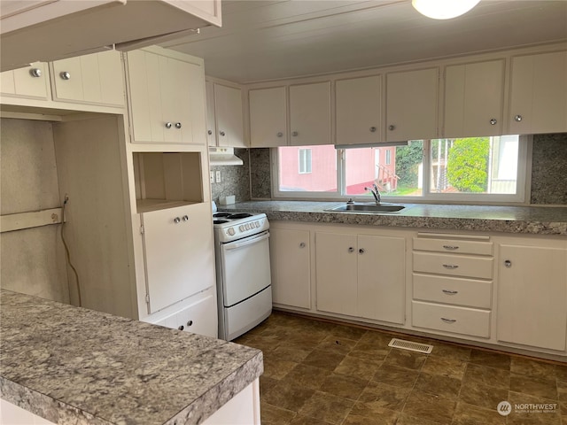 kitchen featuring backsplash, sink, white cabinetry, and white range with gas cooktop