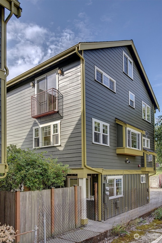 back of property with a balcony