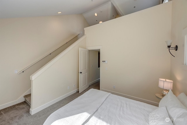 bedroom featuring light carpet and high vaulted ceiling