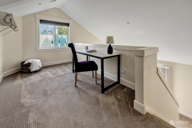 carpeted office with lofted ceiling