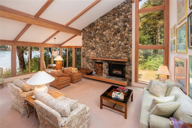 living room featuring vaulted ceiling with beams, plenty of natural light, a fireplace, and carpet flooring