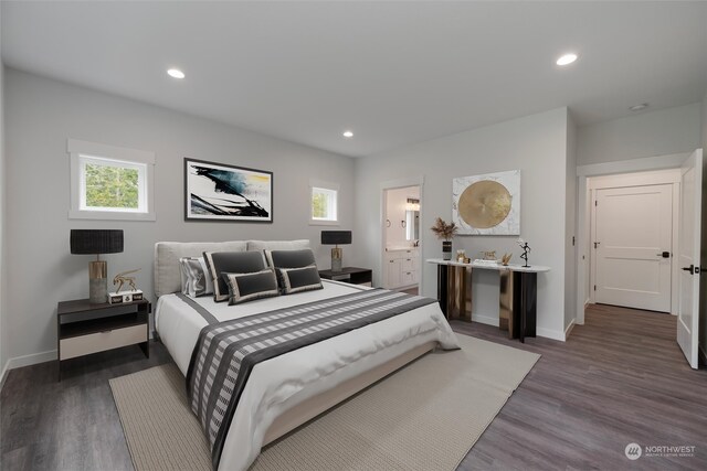 bedroom featuring ensuite bath and dark wood-type flooring