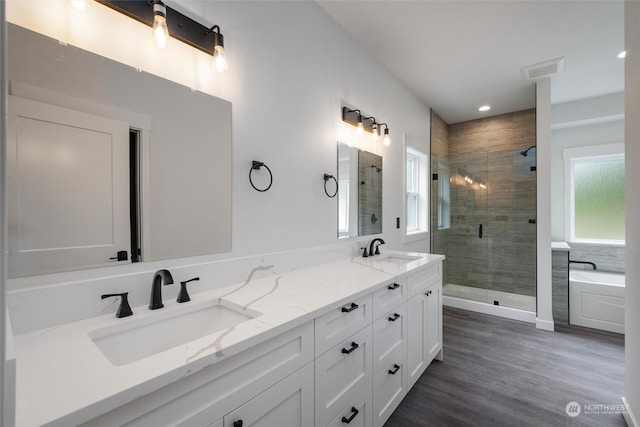 bathroom featuring vanity, separate shower and tub, and wood-type flooring