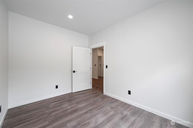 unfurnished room featuring hardwood / wood-style flooring