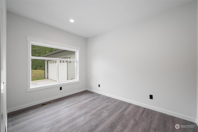 unfurnished room featuring hardwood / wood-style flooring